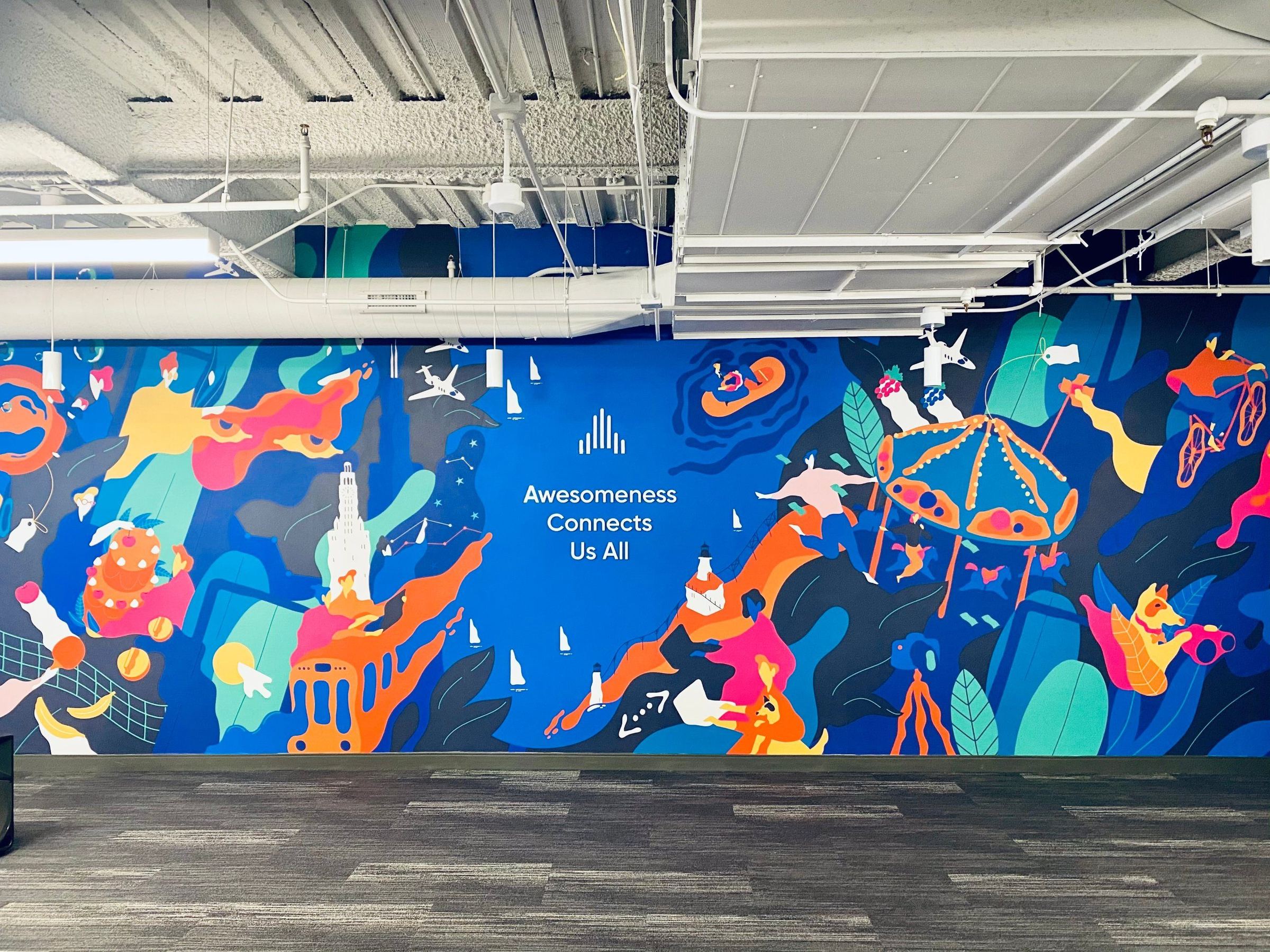 The mural our creatives painted in the Aisle Rocket Chicago office: the skyline, the lake, sailboats, a lighthouse and people mid-leap, with the words Awesomeness Connects Us All across the middle.